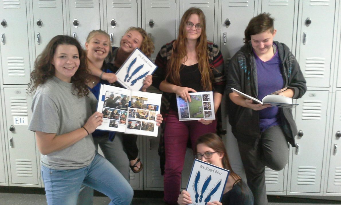 Students showing off Yearbooks